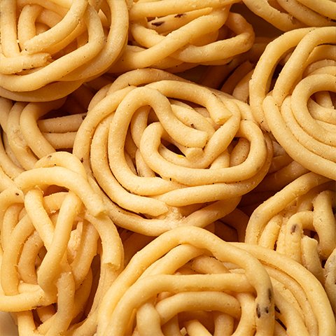 Traditional Thenkuzhal Murukku – light and crispy South Indian snack from Kovilpatti Murukku Kadai.